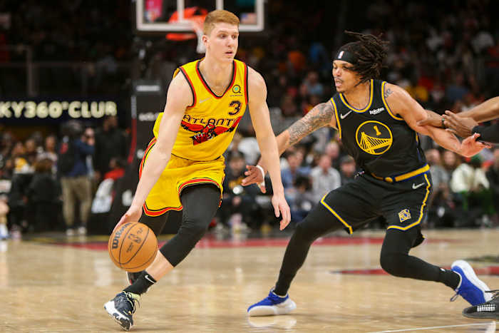 Mar 25, 2022; Atlanta, Georgia, USA; Atlanta Hawks guard Kevin Huerter (3) dribbles past Golden State Warriors guard Damion Lee (1) in the second half at State Farm Arena.